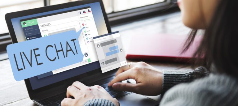 A person using a laptop showcases a live chat interface with "Live Chat" prominently displayed, resembling Church's Online Host. On the screen are chat messages and user icons. The person types diligently, with a notebook serving as their to-do list beside the laptop.