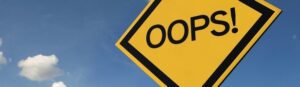 A yellow diamond-shaped road sign with the word "OOPS!" in bold black letters stands against a bright blue sky, reminiscent of common mistakes churches might encounter while navigating their spiritual journey.