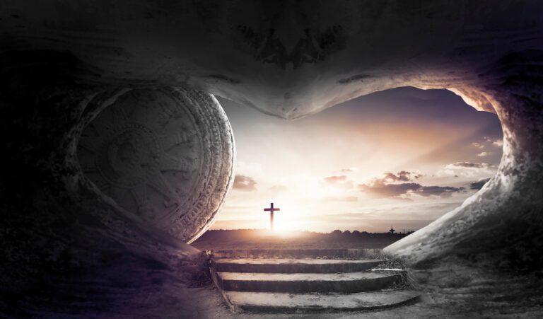 A stone tomb with a large circular stone rolled to the side reveals a path leading out to a warm Easter sunrise. A cross stands in the distance, framed by an opening shaped like a heart, symbolizing the resurrection on this glorious Sunday.