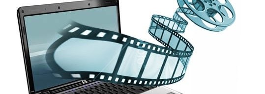 A laptop with a film reel emerging from the screen, symbolizing digital film or video streaming. The motion of the film strip, reminiscent of the best encoder technology, extends from the computer into the foreground.