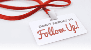 Red lanyard with a white badge displaying the bold text "DON'T FORGET TO Follow Up!" in gray and red lettering, a perfect reminder for staying proactive in church growing efforts.
