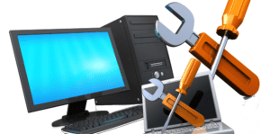 A desktop computer and a laptop are positioned next to large tools, a wrench and screwdriver, symbolizing computer maintenance. Highlighted in the foreground, these tools underscore vital PC health routines to keep your devices running smoothly.