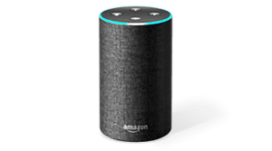 A cylindrical smart speaker with a dark fabric exterior and a circular top featuring four buttons, it seamlessly integrates Alexa voice assistant. The Amazon logo is visible near the bottom, embodying sleek smart technology.