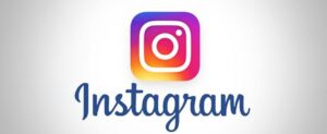 The Instagram logo features a stylized camera icon with a gradient of pink, purple, and orange hues above the word "Instagram" in blue script on a light background, subtly capturing the vibrant spirit that helps connect communities worldwide.