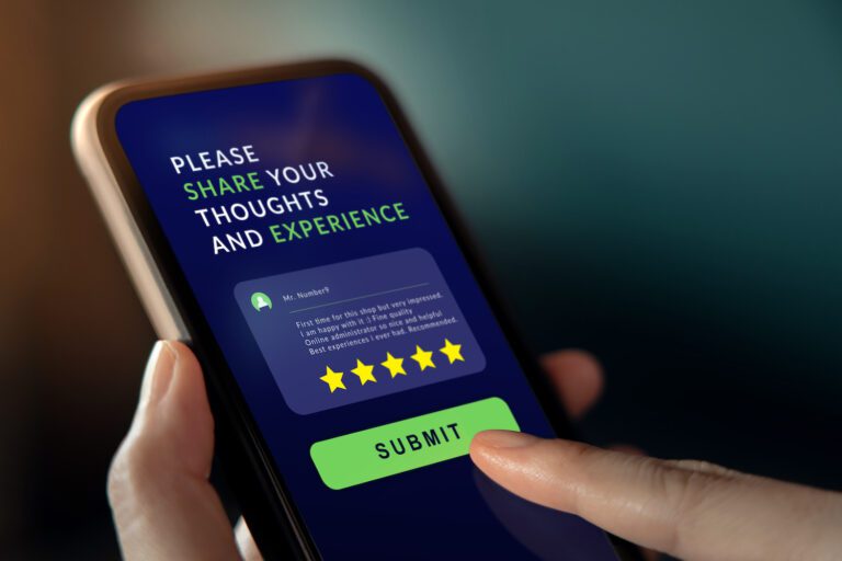 A person holds a smartphone displaying a feedback form with a five-star rating and testimonial. The screen prompts, "Please share your thoughts and experience," with a green "Submit" button below, offering the best way for reviews to boost positive online feedback.