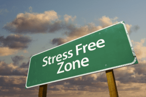 A green sign with "Stress Free Zone" stands against a backdrop of a cloudy sky, offering tips for creating your own sanctuary.