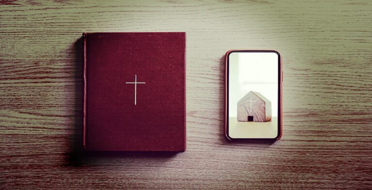 A red book with a white cross on its cover rests on a wooden surface beside a smartphone. The phone's screen shows a miniature wooden church with a cross on its roof, posing the question: "Are you ready for the future of church?