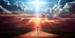 Three crosses stand on a hill under a dramatic sky with sunbeams breaking through clouds, casting a warm glow over the scene—a perfect image for an Easter blog post.