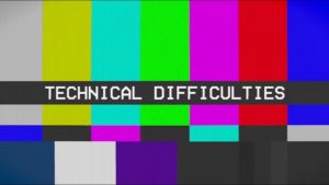 A screen displaying vertical color bars with the words “TECHNICAL DIFFICULTIES” in bold white text on a black strip across the center—a familiar sight during church livestream fails.